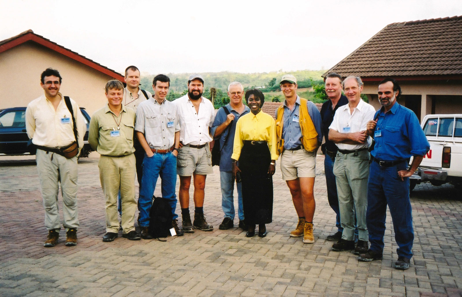 [The manageress of the Coconut Grove Hotel at Obuasi poses with the group.]